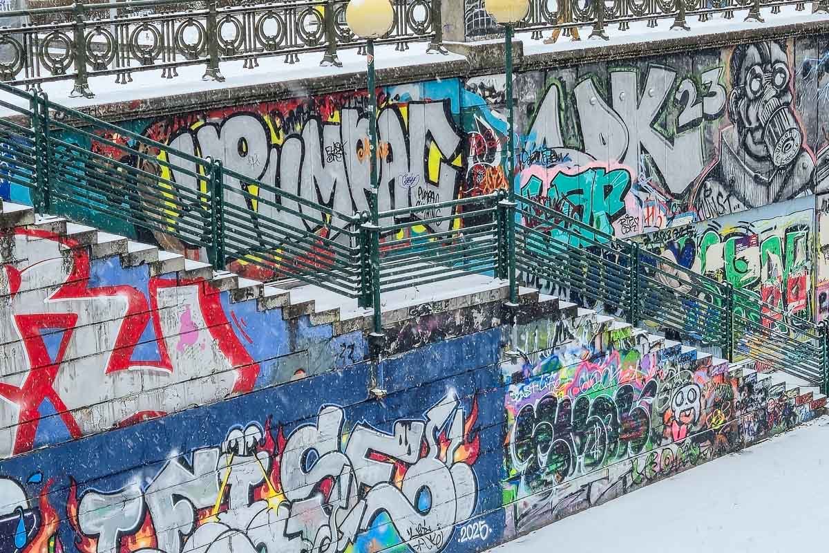 Could not look away Dense layered graffiti covering a long wall, text and abstraction competing, no single image dominant