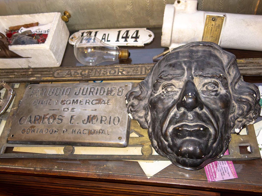 Could not look away_9 Weathered bronze memorial plaque with a deeply modeled face, aged surface, partial inscriptions