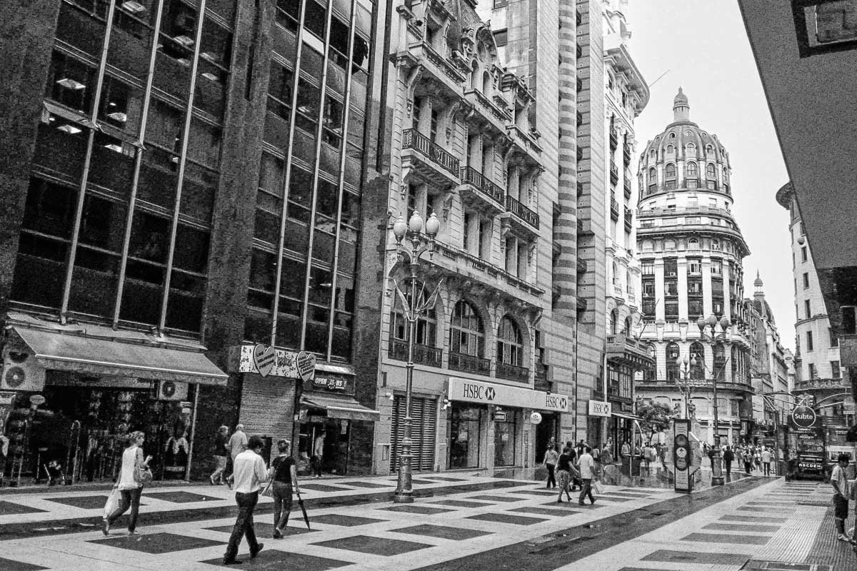 Europe H_7 Black and white street scene in Buenos Aires, checkered plaza pavement, domed building in background, HSBC storefront