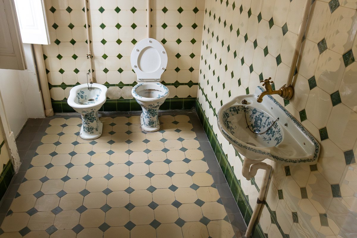 Found Azulejo-tiled bathroom with patterned floor and walls, bidet and toilet, classic Portuguese interior