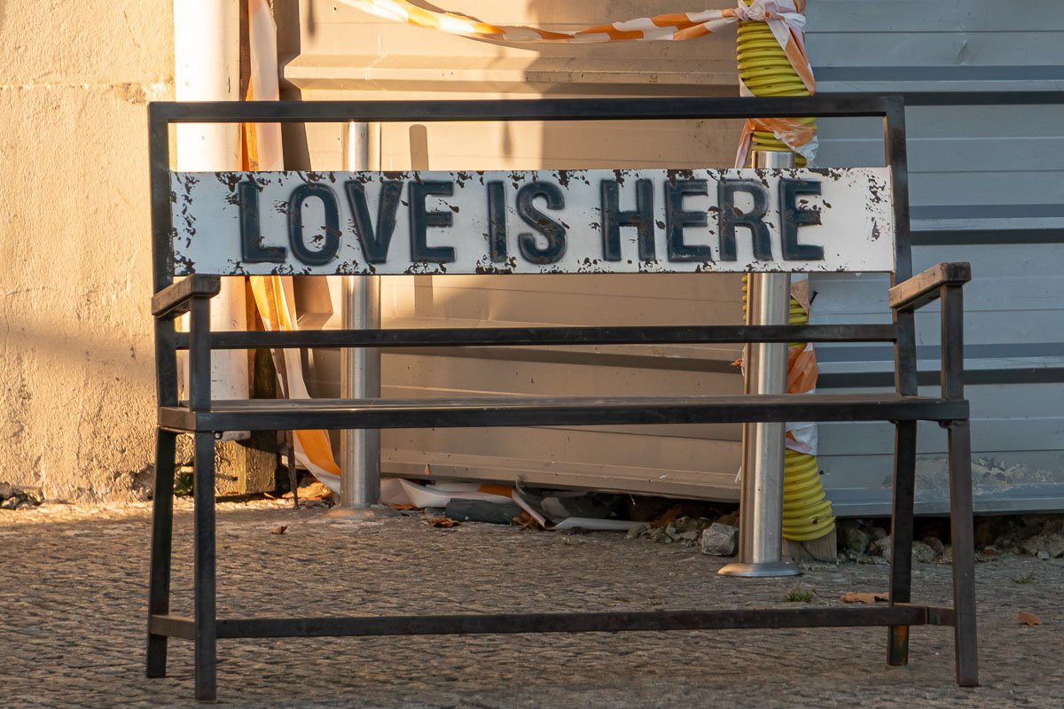 Found_12 Rusted bench with a sign: Love is Here.
