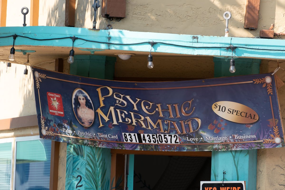 Signs Turquoise-painted storefront with hand-lettered sign reading Pay the Minimum, casual and slightly defiant