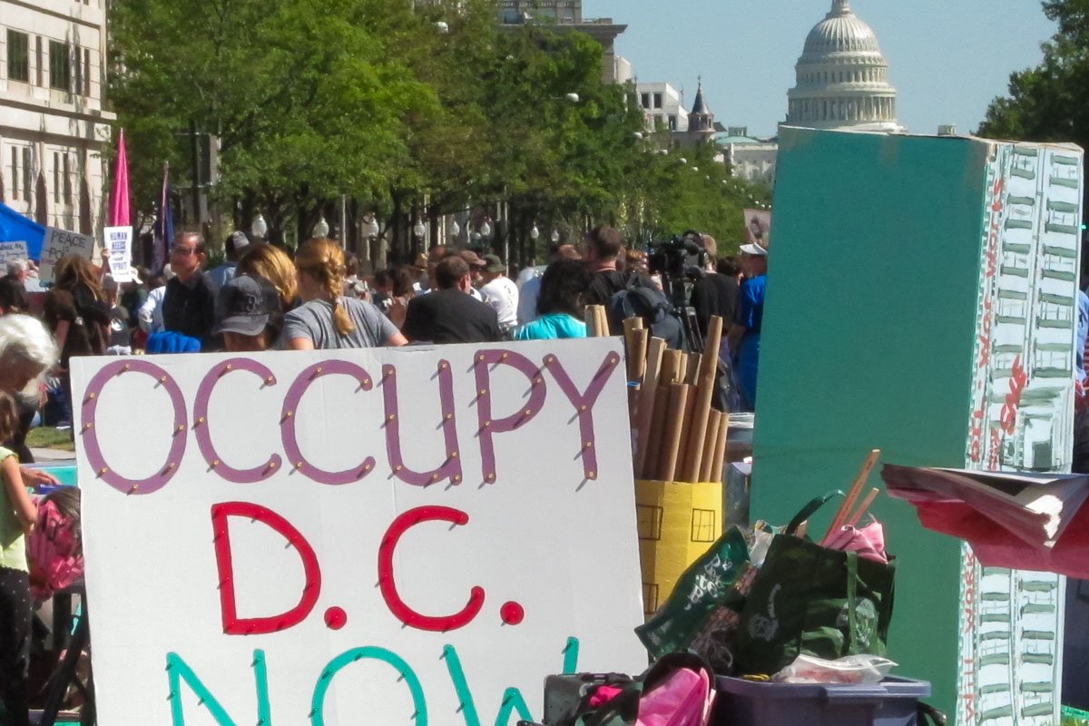 Signs_7 Handmade protest sign reading OCCUPY D.C. NOW at a demonstration with the Capitol building visible behind