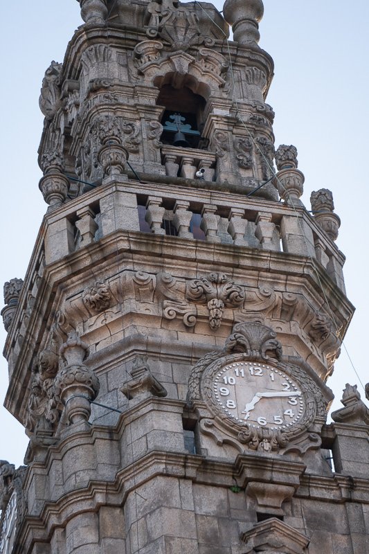clocks_4 Close view of an elaborate gothic stone clock tower, carved decoration around the dial